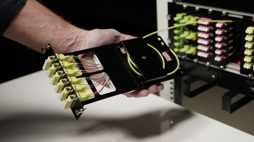Fiber Products Produktion: Montage eines bestückten Spleißmoduls am 19-Zoll-Baugruppenträger